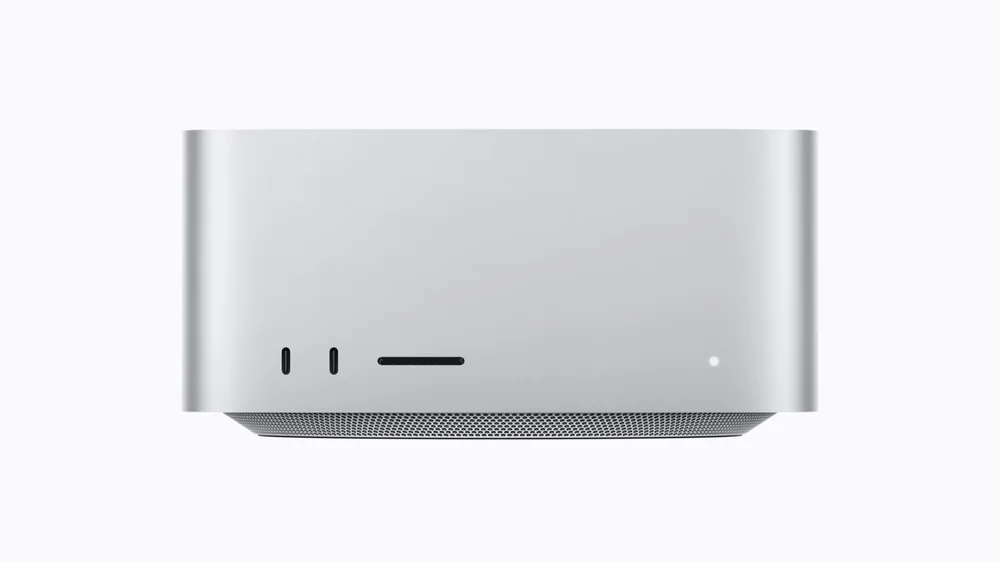 Silver 2026 Mac Studio viewed from the front, showing two USB-C connectors and an SDXC slot